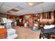 This is an unfinished basement featuring a brick fireplace, wood paneling and tiled ceiling at 2798 Tralyn Ct, Decatur, GA 30034