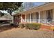 Brick home exterior showcasing porch with white railings and manicured shrubs at 2798 Tralyn Ct, Decatur, GA 30034