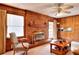 This is an airy living room with a brick fireplace, wood paneling, and bright natural light at 2798 Tralyn Ct, Decatur, GA 30034