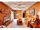 Inviting living room featuring a brick fireplace, wood paneling, and an adjoining kitchen at 2798 Tralyn Ct, Decatur, GA 30034