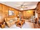 Cozy living room with wood paneling, brick fireplace, and a comfortable leather sofa at 2798 Tralyn Ct, Decatur, GA 30034