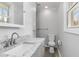 Bathroom vanity with granite countertop, modern faucet, sink, and toilet next to window at 2825 Middleburg Dr, Atlanta, GA 30349