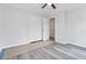 Bedroom featuring new gray-toned flooring, closet with white doors, and a ceiling fan at 2825 Middleburg Dr, Atlanta, GA 30349