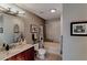 A stylish bathroom with a granite countertop, cherry cabinets, and a bathtub with tile surround at 400 W Peachtree Nw St # 3216, Atlanta, GA 30308