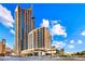 A view of the high-rise condo building with blue sky and some clouds in the background at 400 W Peachtree Nw St # 3216, Atlanta, GA 30308