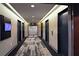 A carpeted hallway leading to multiple elevators with modern lighting and neutral color scheme at 400 W Peachtree Nw St # 3216, Atlanta, GA 30308