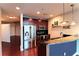 Bright kitchen with stainless steel fridge, modern cabinets and eat-in bar at 400 W Peachtree Nw St # 3216, Atlanta, GA 30308