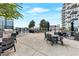 A spacious outdoor lounge with grill, tables, chairs, and a view of the surrounding landscape at 400 W Peachtree Nw St # 3216, Atlanta, GA 30308