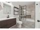 Modern bathroom with a shower-tub combo, tiled walls, and a dark wood vanity at 434 Mcgill Ne Pl, Atlanta, GA 30312