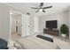 Bedroom with ceiling fan, TV on stand, and attached bathroom with a tiled floor at 434 Mcgill Ne Pl, Atlanta, GA 30312