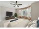 Bedroom with ceiling fan, TV on stand, bench, and a large window at 434 Mcgill Ne Pl, Atlanta, GA 30312