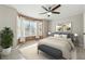 Bright bedroom with a large window, ceiling fan, and light wood-look flooring at 434 Mcgill Ne Pl, Atlanta, GA 30312