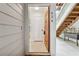 Front entrance with tile floor, white door and natural wood staircase at 434 Mcgill Ne Pl, Atlanta, GA 30312