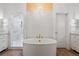 A luxurious bathroom featuring a soaking tub, glass shower and white cabinetry at 170 Boulevard Se # 412E, Atlanta, GA 30312