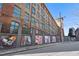 Large brick building featuring an old-world design, with colorful street art on lower level walls at 170 Boulevard Se # 412E, Atlanta, GA 30312