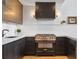 Gourmet kitchen with custom range hood, top-of-the-line appliances, and quartz countertops at 170 Boulevard Se # 412E, Atlanta, GA 30312