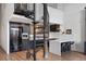Modern kitchen adjacent to the spiral staircase features sleek appliances, bar seating, and contemporary finishes at 170 Boulevard Se # 412E, Atlanta, GA 30312