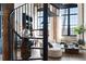 Living room features a spiral staircase, exposed brick, and large windows, showcasing the industrial-chic design at 170 Boulevard Se # 412E, Atlanta, GA 30312