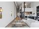Open living space with high ceilings, exposed brick, spiral staircase, and a modern kitchen in background at 170 Boulevard Se # 412E, Atlanta, GA 30312