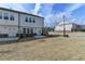 Backyard featuring lawn, small patio, and partial views of neighboring homes at 1883 Frisco Way, Suwanee, GA 30024