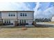 Exterior view of backyard showcasing lawn, and a patio area with street view at 1883 Frisco Way, Suwanee, GA 30024