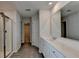 Bright bathroom with double sink vanity, walk-in shower, closet, and stylish gray wood-look flooring at 1883 Frisco Way, Suwanee, GA 30024