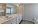 Bright bathroom featuring a double sink vanity, large mirror, and stylish gray wood-look flooring at 1883 Frisco Way, Suwanee, GA 30024