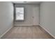 Neutral bedroom featuring plush carpet, a bright window, and a gray-painted door at 1883 Frisco Way, Suwanee, GA 30024