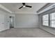Spacious bedroom with neutral tones, a ceiling fan, and carpet floors at 1883 Frisco Way, Suwanee, GA 30024