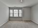 Spacious bedroom featuring plush carpeting and large windows for natural light at 1883 Frisco Way, Suwanee, GA 30024