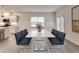 Formal dining room with a large table, modern chairs, and views into the updated kitchen at 1883 Frisco Way, Suwanee, GA 30024