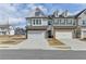 Charming two-story townhome featuring brick accents, attached two-car garage, and well-manicured landscaping at 1883 Frisco Way, Suwanee, GA 30024