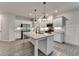 Spacious kitchen featuring granite countertops, stainless steel appliances, a kitchen island, and wood-look floors at 1883 Frisco Way, Suwanee, GA 30024