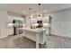 Kitchen with a large island featuring granite countertops, stainless steel appliances, and white cabinetry at 1883 Frisco Way, Suwanee, GA 30024