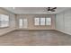 Spacious living room with wood floors, ceiling fan, and natural light at 1883 Frisco Way, Suwanee, GA 30024