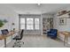 Bright home office with a built-in bookshelf, desk, and a large window at 1883 Frisco Way, Suwanee, GA 30024