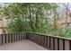 A cozy covered back porch with painted wood railing overlooks a wooded scene at 20 Ivy Ne Rdg, Atlanta, GA 30342