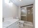 This bathroom features a marble countertop, a sink, a toilet, and a shower with sliding glass doors at 20 Ivy Ne Rdg, Atlanta, GA 30342