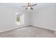 A bright bedroom features neutral walls, carpet, a ceiling fan, and a window at 20 Ivy Ne Rdg, Atlanta, GA 30342