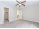 A carpeted bedroom shows a ceiling fan, an open closet, and an open door to another room at 20 Ivy Ne Rdg, Atlanta, GA 30342