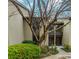 Inviting condo exterior featuring well-maintained landscaping, mature tree, and private entrances at 20 Ivy Ne Rdg, Atlanta, GA 30342