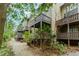 Exterior shot of multi-level balconies of condos, surrounded by gravel path and foliage at 20 Ivy Ne Rdg, Atlanta, GA 30342