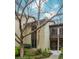 Exterior shot of a condo with tree lined yard and sidewalk leading to the front door at 20 Ivy Ne Rdg, Atlanta, GA 30342