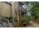 Exterior shot of multi-level condo balconies with stairway surrounded by foliage at 20 Ivy Ne Rdg, Atlanta, GA 30342