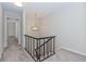 Upstairs hallway features carpet, chandelier and railing at 20 Ivy Ne Rdg, Atlanta, GA 30342