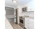 Bright, updated kitchen with stainless steel appliances, granite countertops, and white cabinetry at 20 Ivy Ne Rdg, Atlanta, GA 30342