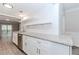 Well-lit kitchen with stainless steel appliances, granite countertops, subway tile backsplash, and open shelves at 20 Ivy Ne Rdg, Atlanta, GA 30342