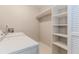 A laundry room shows a washer, a dryer, and white shelves at 20 Ivy Ne Rdg, Atlanta, GA 30342