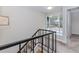 Upstairs staircase with black railing and a door at 20 Ivy Ne Rdg, Atlanta, GA 30342