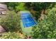 An aerial view of a blue outdoor tennis court surrounded by green landscaping at 20 Ivy Ne Rdg, Atlanta, GA 30342